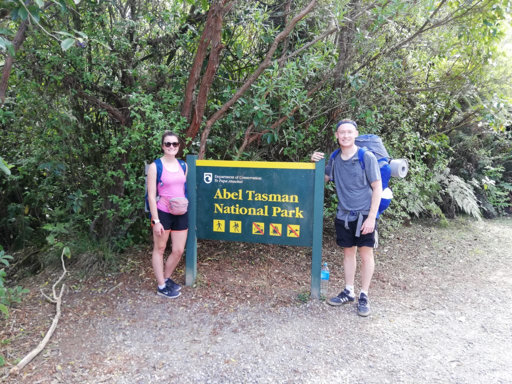 Standing beside the Abel Tasman National Park sign